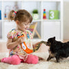 Little girl playing with Squeaky dog toy Wild Forest Tiger with her dog